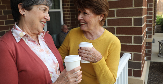 two elderly women drinking coffee