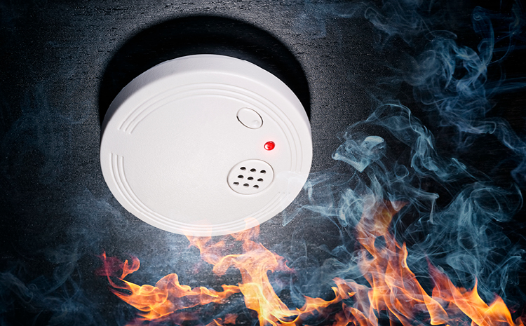 a smoke detector with fire below it