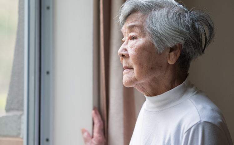 an elderly woman looking out the window