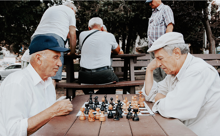 two elderly men playing chess