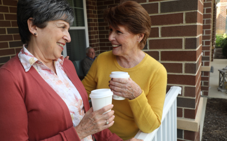 two elderly women drinking coffee