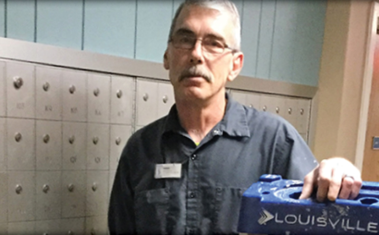 a male staff member holding a ladder