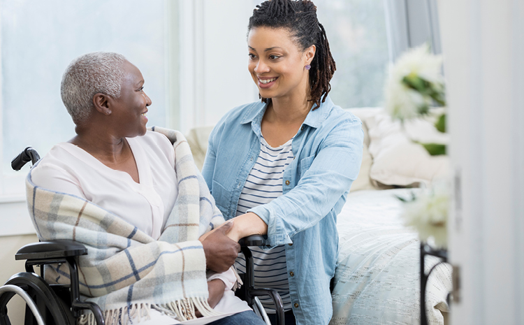 a daughter and elderly mother smiling