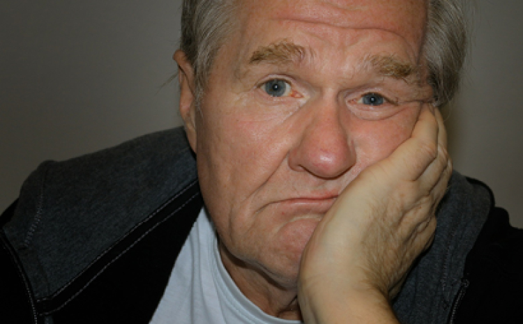 an elderly man looking bored