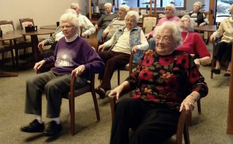 a group of elderly women sitting in chairs