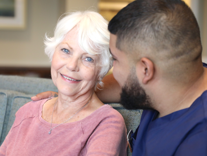 a male worker spends time with senior female respite client