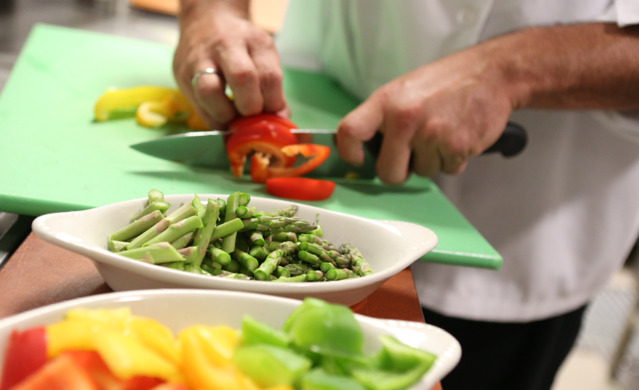 close up view of chef preparing royal atrium inn restaurant style meal