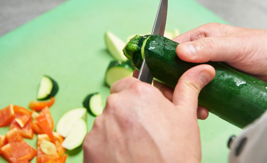 close up of royal park place chef's hands cutting vegetables