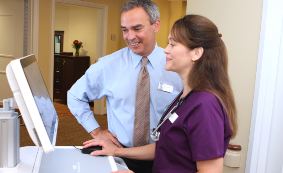 nursing home manager speaks with healthcare staff