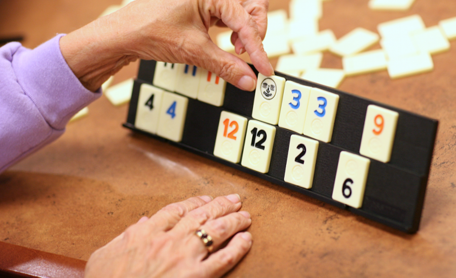 hands of a providence respite client are shown playing rummikub