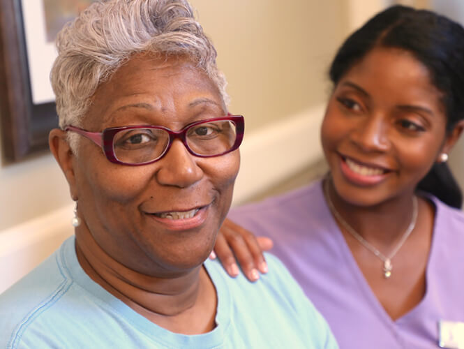 a female resident aide and her senior respite care resident 