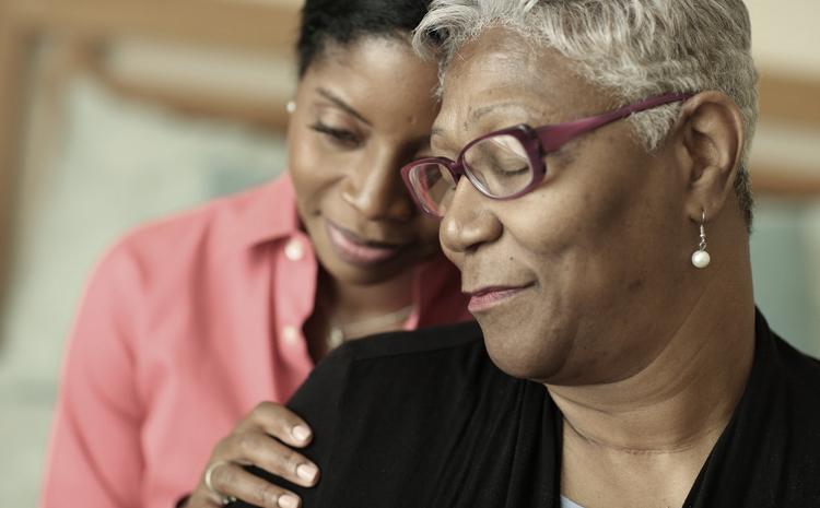 a daughter consoling her elderly mother