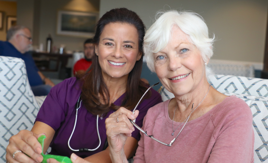 female geriatric care manager smiles with park place resident