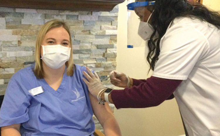 a healthcare worker getting a shot