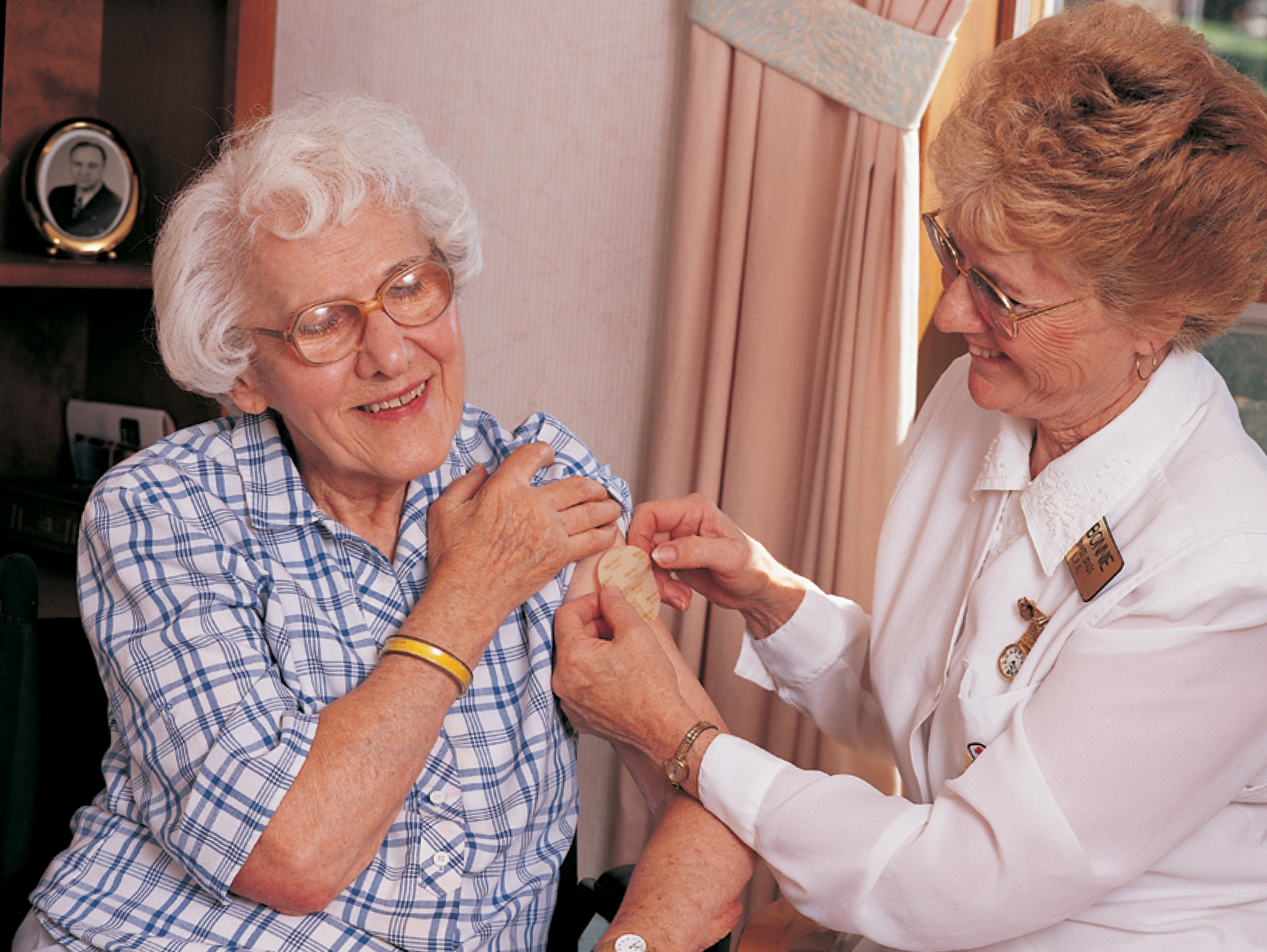 woman from early 1990s helps senior woman with home healthcare