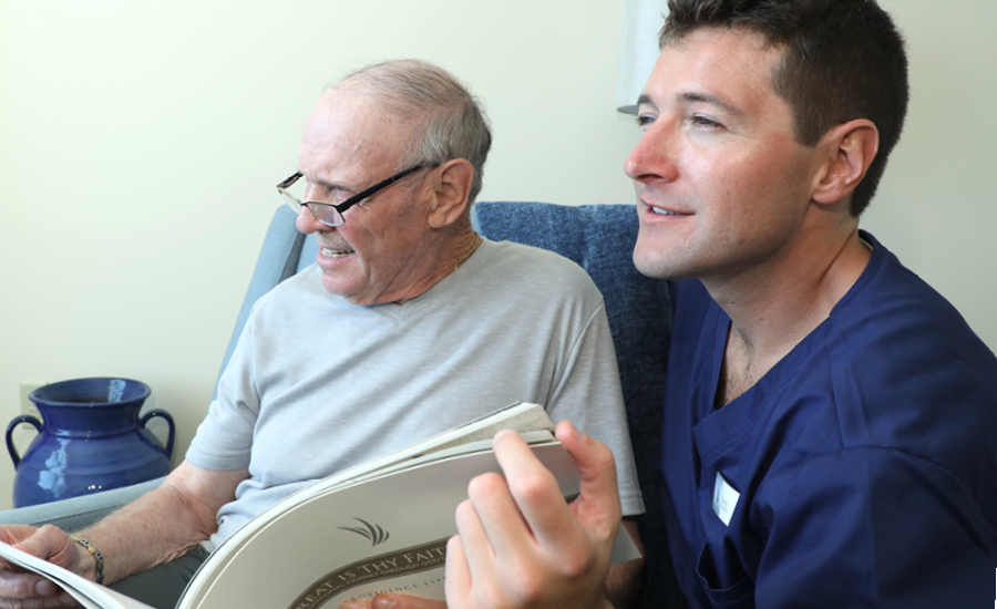 providence hospice cna discusses palliative care plan to senior male patient