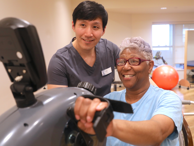 male rehabilitation therapists works with senior female