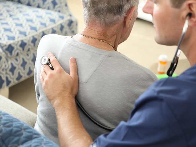 a providence hospice cna stands with one of her palliative care patients