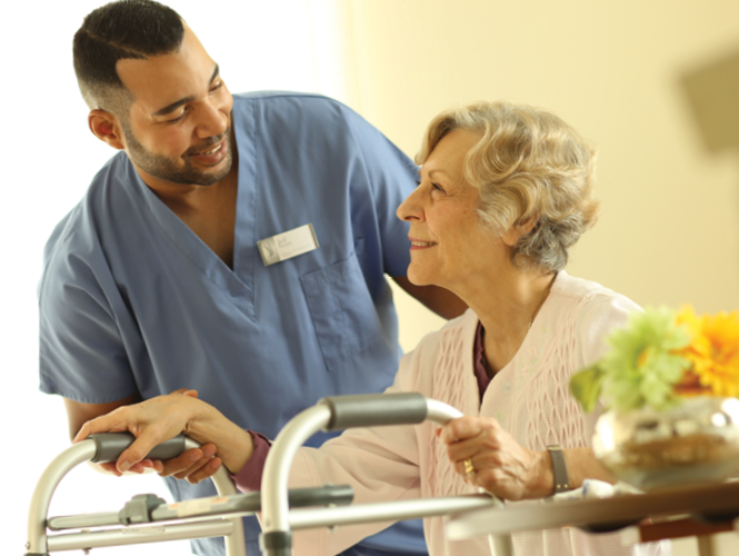 a healthcare worker smiling at an elderly woman