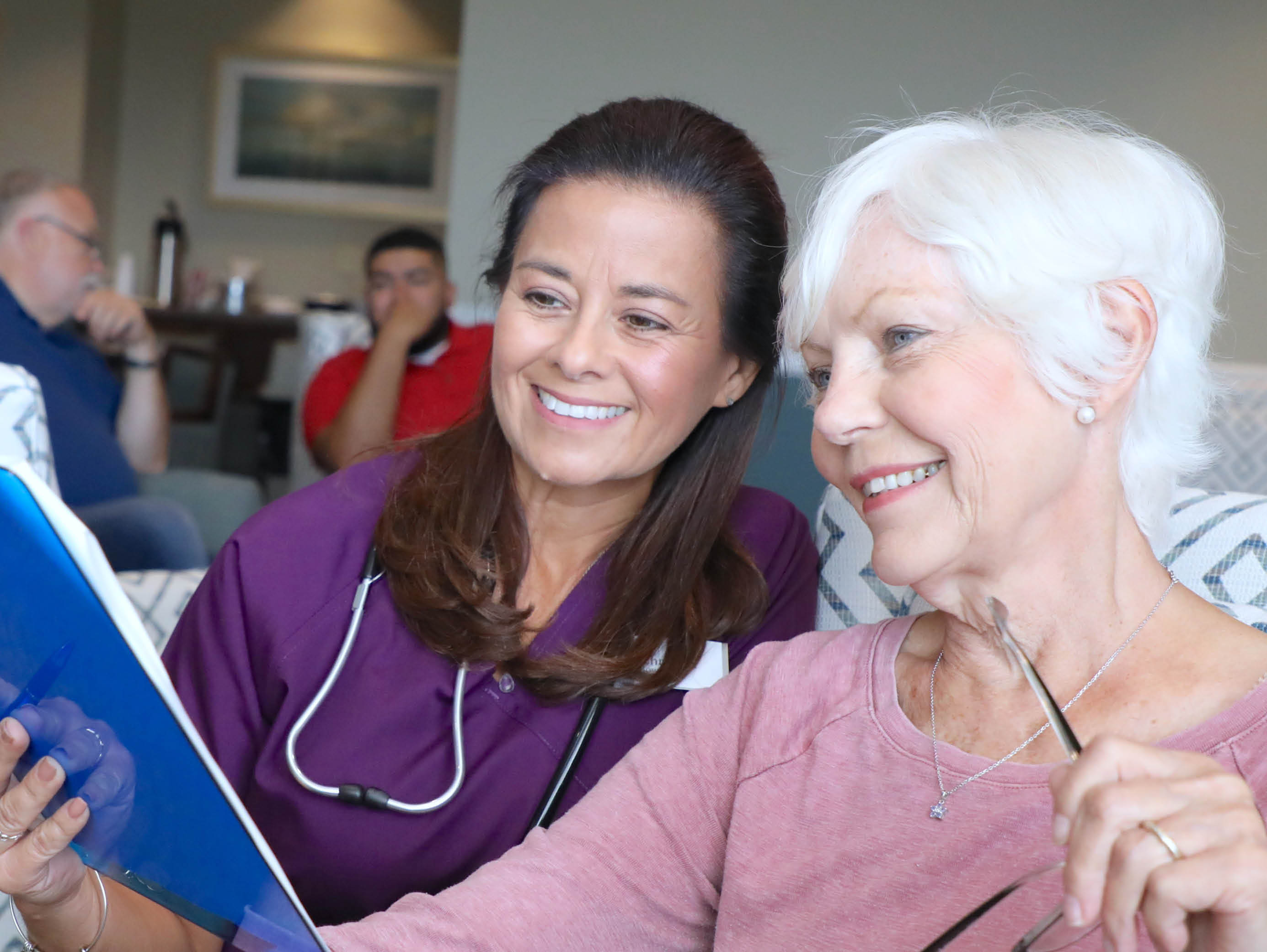 a healthcare working reviewing documents with an elderly woman