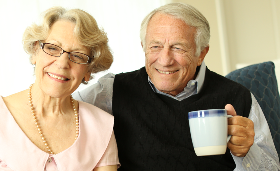 Senior couple enjoying breakfast in their royal park place apartment