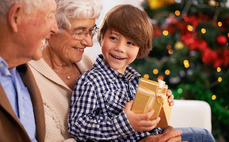 a grandson getting a gift from his grandparents