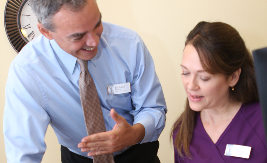 male providence life services manager speaks to female healthcare staff