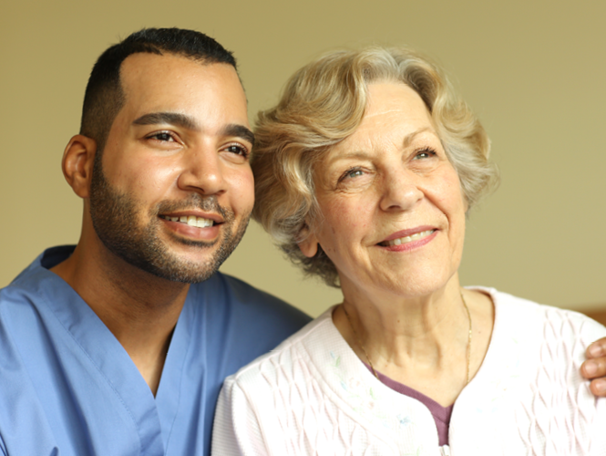 male providence hospice worker stands with female palliative care worker