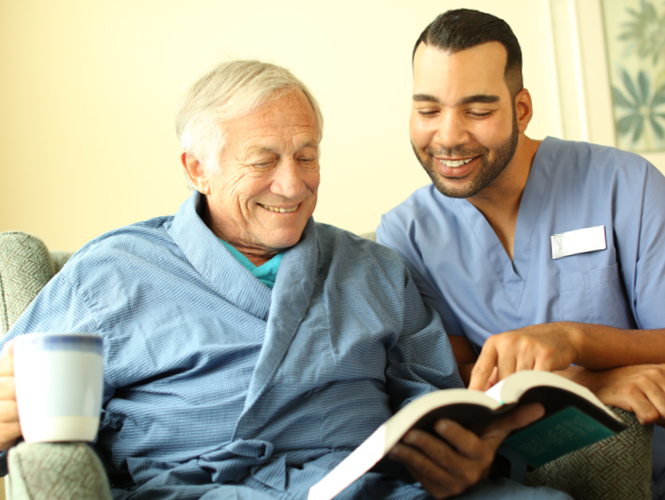 a male cna assists a male senior resident at park place st John