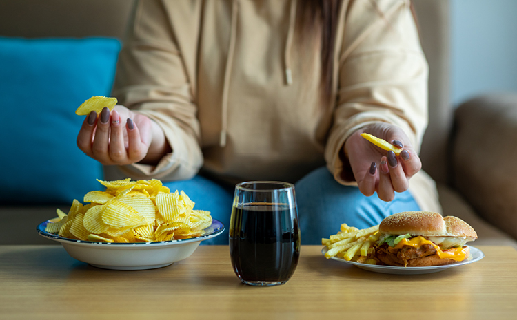 a woman with junk food in front of her