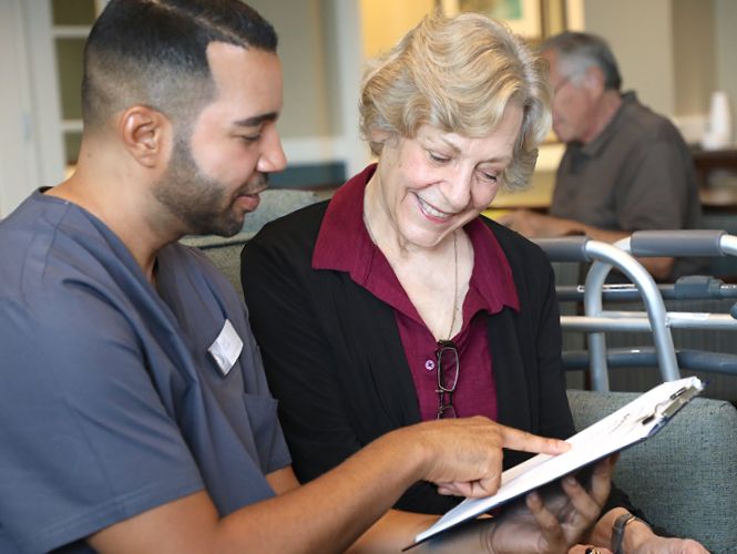 male geriatric care manager discusses care plan with senior park place female resident