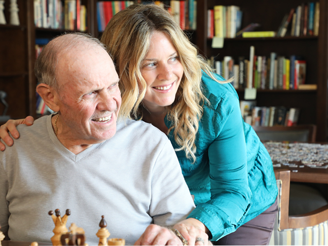 a woman embracing an elderly man