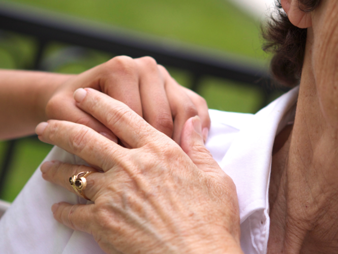 providence hospice volunteer comforts providence hospice patient, hand over hand