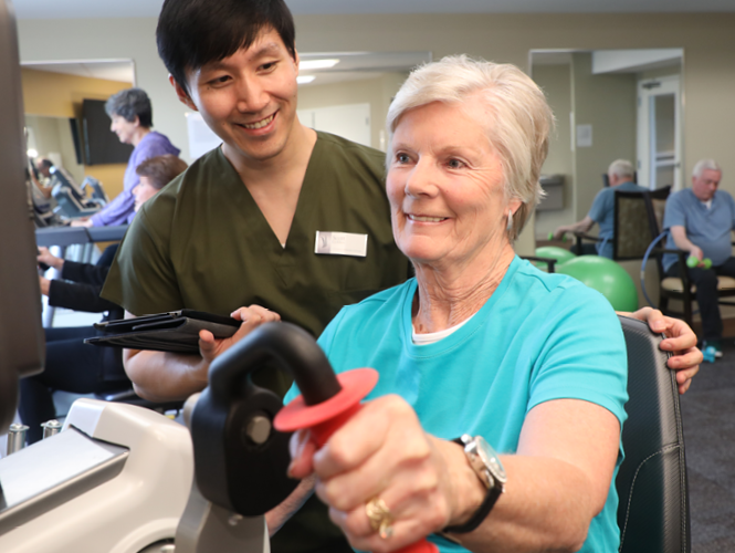 therapist assists park place female resident on her virtusense health plan