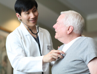 a doctor takes his patients vitals in victorian village health & wellness center