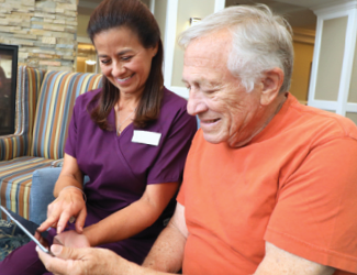 picture of providence solutions caregiver helping senior man understand his benefits