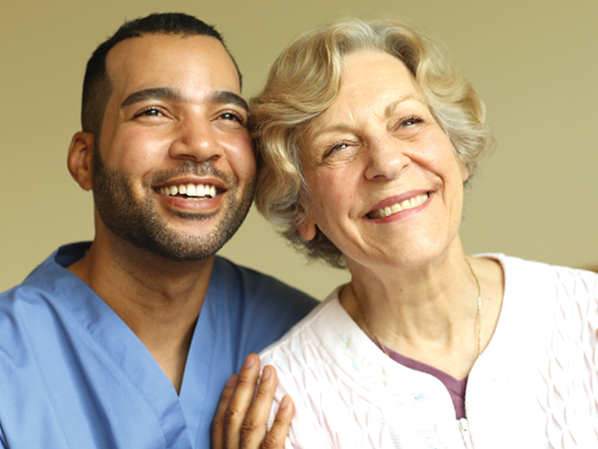 male cna and senior woman at providence thankful for donations