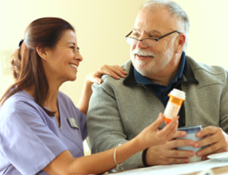 a female CNA assists male resident with medication