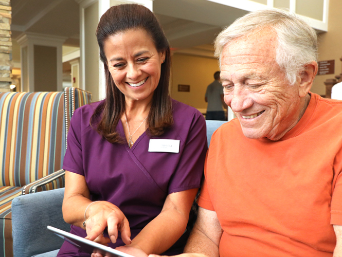 a healthcare worker helping an elderly man