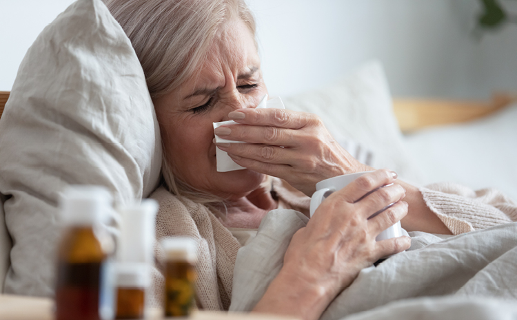 an elderly woman sick in bed