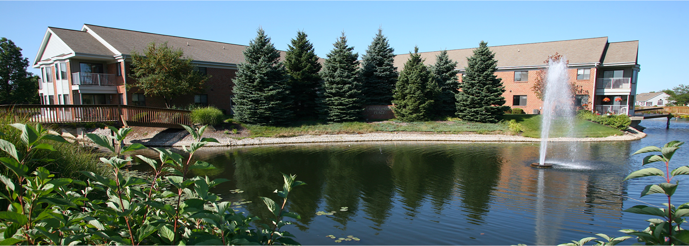 exterior shot of royal park place and lovely lake surrounding campus