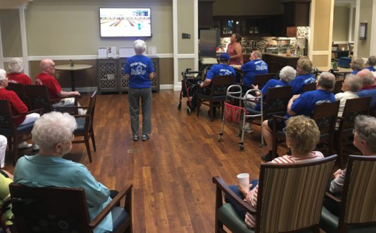 elderly folks playing wii bowling