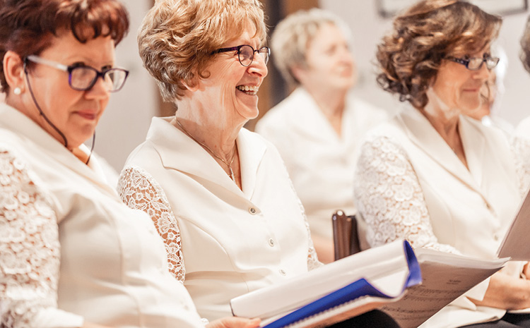 Elderly women in a group setting smiling