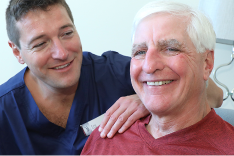 male therapist assists female rehab patient