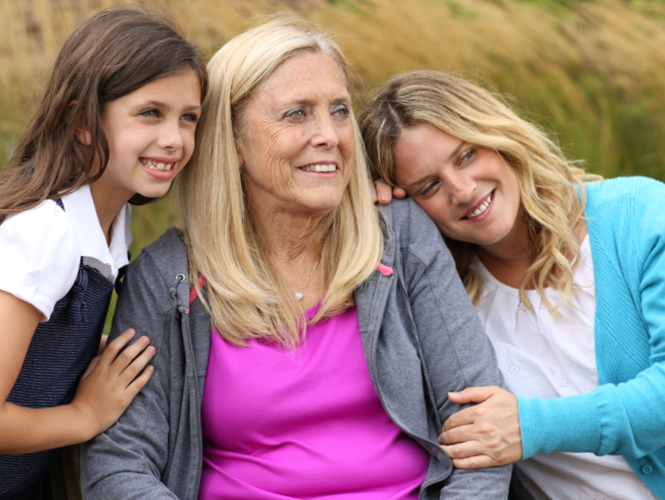 an older adult female enjoys the outdoors at royal park place with her two female grandchildren