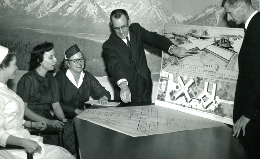 the founders of providence life services look at a model of the community