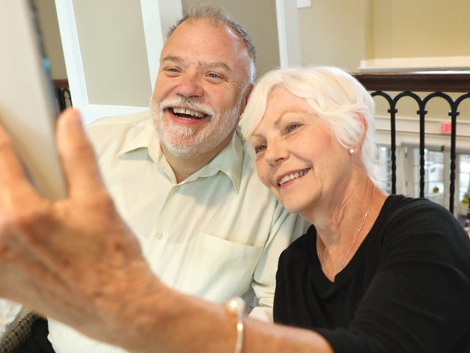 an elderly couple taking a selfie