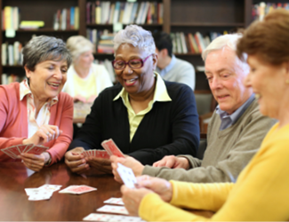 four residents gather together and play board games together