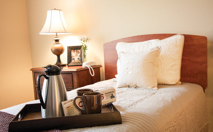 coffee waiting on a tray on the bed