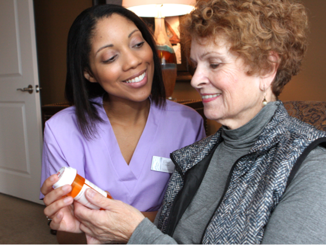 young female providence employee explains medicine to senior female